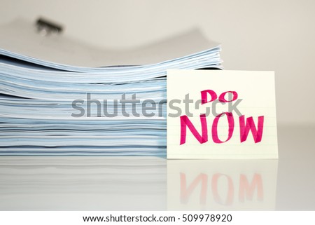 Do Now; Stack of Documents on white desk and Background.
