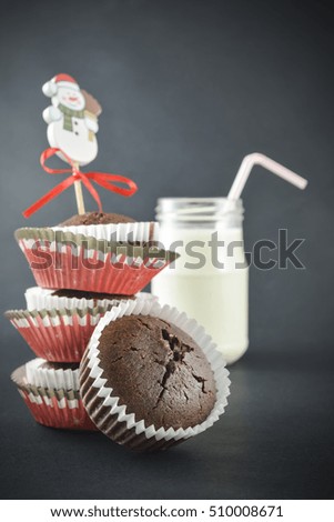 muffin with cup of milk on black background for Christmas