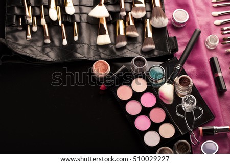 Make up artist theme. Various makeup products. Top view. Set of professional cosmetic: make-up brushes, shadows, lipstick. Place for typography and logo.