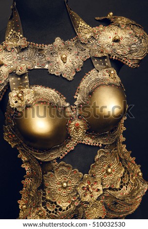 Female mannequin in creative golden glitter costume 