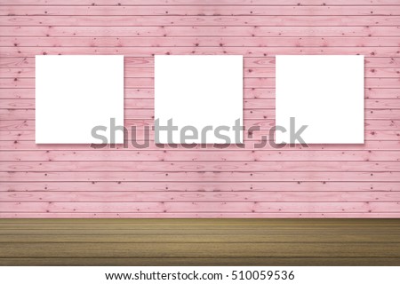 Empty wood table and Three canvas frame on pink pastel wooden wall background. product display template. Business presentation.Three empty frames in a room against a wooden wall