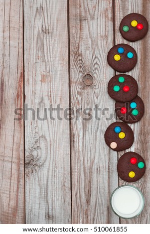 Christmas cookies and milk on wooden background.