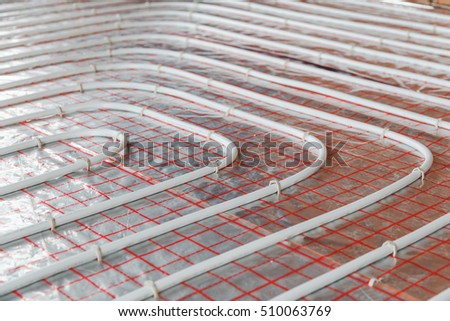Underfloor heating installation. Close up on water floor heating system interior. plumbing pipes. Individual Heating. Royalty-Free Stock Photo #510063769