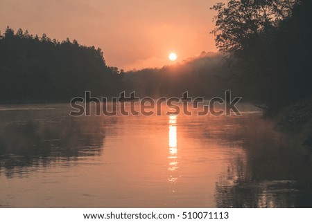 colorful orange sunrise over the lake in summer - vintage effect