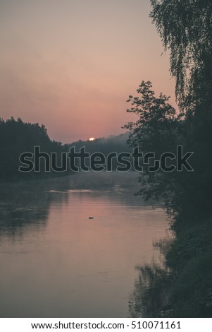 colorful orange sunrise over the lake in summer - vintage effect