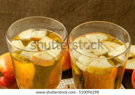 Hot apple cider with apples and slices in cups, warm in winter concept