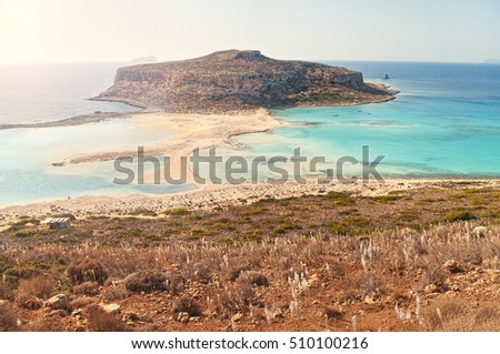 cross-processed view of Balos Bay and Cape Tigani from mountain on island of Crete on sunny summer day with sun shining in right upper coner, Crete, Greece Royalty-Free Stock Photo #510100216