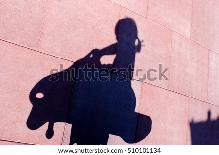 shadow of the child is swinging horse on playground