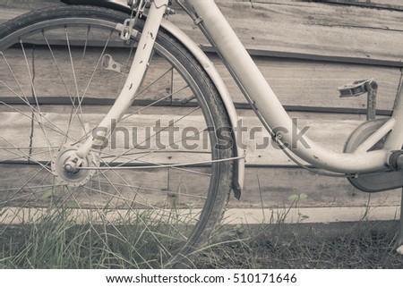 old bicycle wooden background ,old color