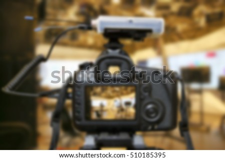 Blurred Digital single lens reflex camera on tripod shooting for stock photos