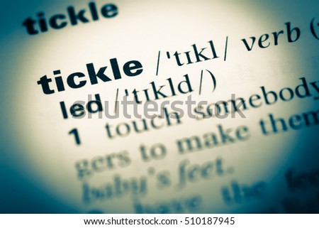 Close up of old English dictionary page with word tickle