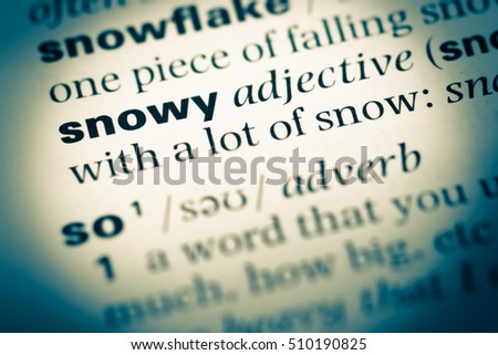 Close up of old English dictionary page with word snowy