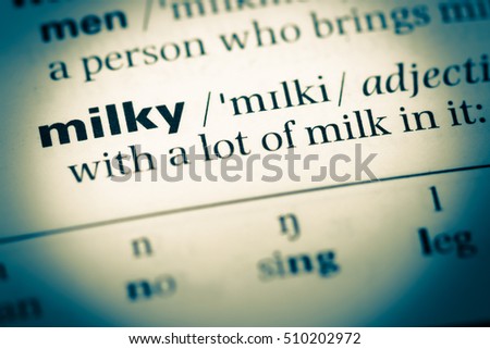 Close up of old English dictionary page with word milky