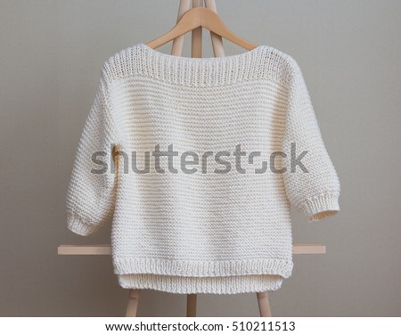 White sweater knitted manually