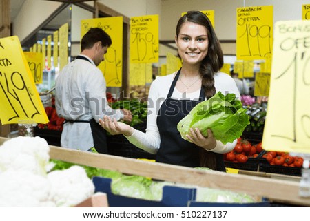 smiling european shop people standing near cabbage in grocery