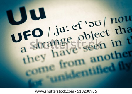 Close up of old English dictionary page with word ufo
