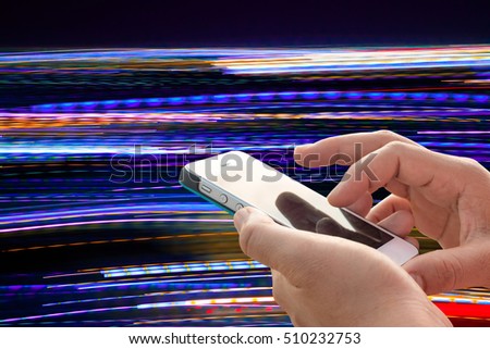 Hand using mobile phone on motion blur background