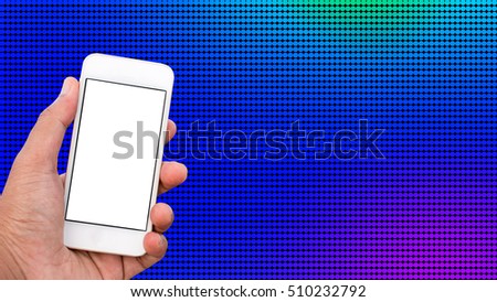 Hand holding mobile smart phone with blank screen in vertical position, dot background - mockup template