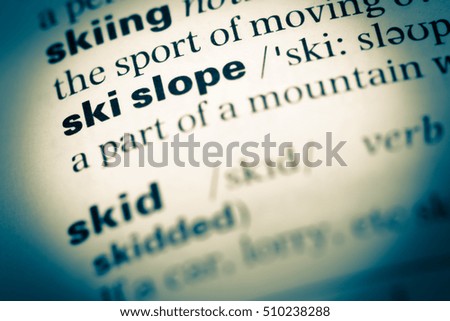 Close up of old English dictionary page with word ski slope