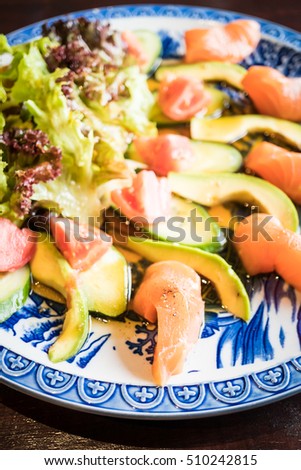 Selective focus point on Fresh Salad salmon with avocado and vegetable in plate - Dark Processing style and Vignetting Effect
