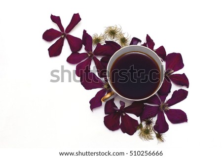 Composition with a cup of tea and flowers clematis. Flat lay, top view