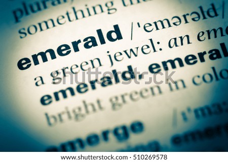 Close up of old English dictionary page with word emerald