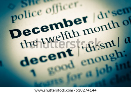 Close up of old English dictionary page with word December