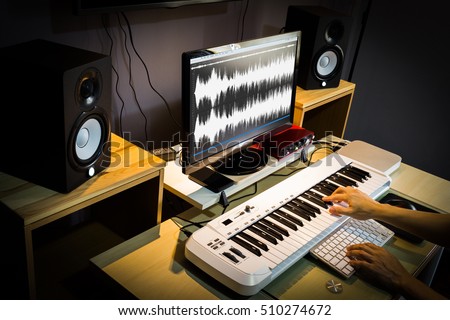 sound engineer, composer working in digital editing & recording studio for post production or broadcasting