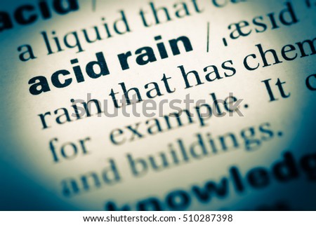 Close up of old English dictionary page with word acid rain