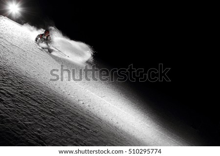 a skier makes a turn in deep snow