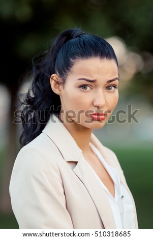 Disappointed funny cute girl woman face against city background