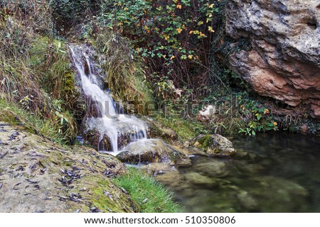 Waterfall in a place of lush forest. Manzanera.Teruel. Spain