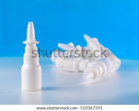 nasal spray bottle in front of other bottles pile, shallow depth of field, advertisement concept