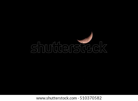 The yellow crescent moon with black background