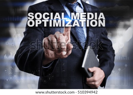 Businessman is pressing button on touch screen interface and selecting social media optimization.