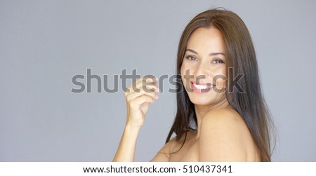 Cute single young adult woman with hand near face Royalty-Free Stock Photo #510437341