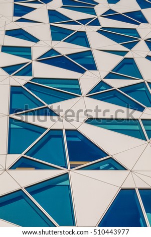 Glass and concrete architectural exteriors. Asymmetrical windows.