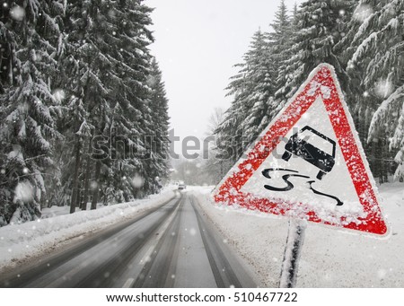 Road sign warning against slippery road due to snow ice Royalty-Free Stock Photo #510467722