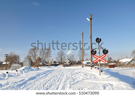 Unguarded railway crossing in the winter. Countryside.