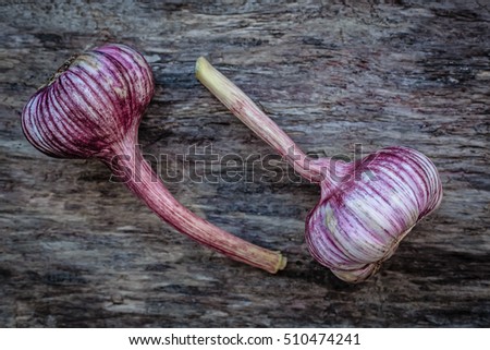 a couple of heads of garlic on an old wooden surface, harvest purple kohlrabi, healthy fruit kohlrabi