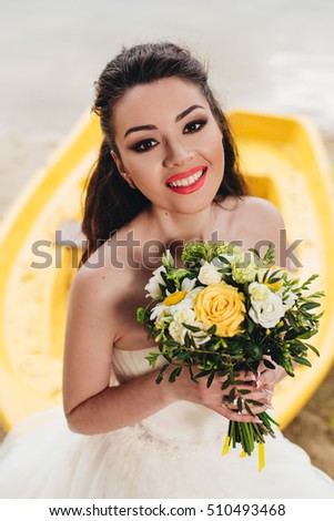 Bride smilind and sitting on the boat