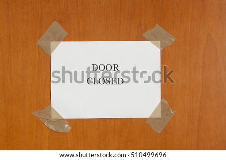 sign attached on the door that says "Door closed"