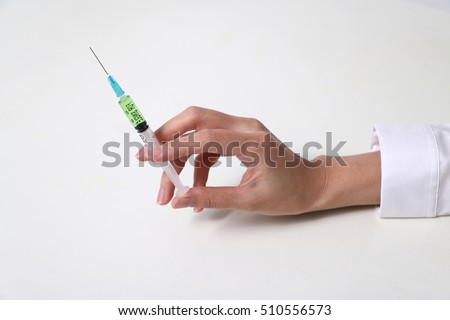 injector held by woman hand Royalty-Free Stock Photo #510556573