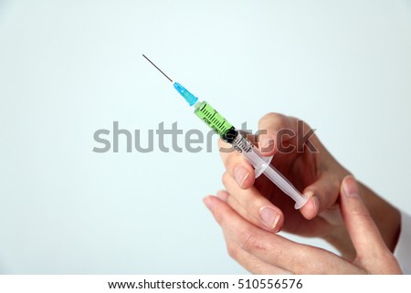 injector held by woman hand Royalty-Free Stock Photo #510556576