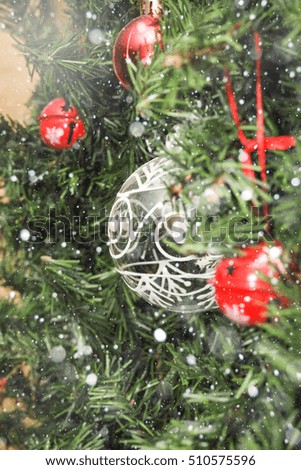 Christmas decorations on a Christmas tree under snow