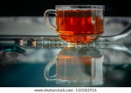 Shiny transparent glass cup with tea.