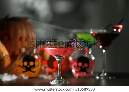 Tasty cocktail with decor for Halloween, on blurred background