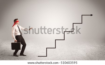 A male office worker standing blindfolded and confused with arrows pointing in different directions concept