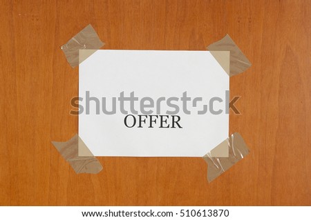 sign hanging on the door that says "offer"