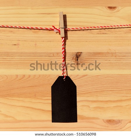 Blank black price tag on the background of wooden planks
